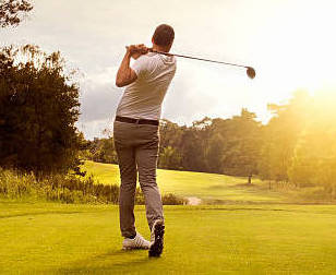 Man playing golf at golf course